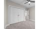 Neutral bedroom featuring carpet floors, ceiling fan and closet with white doors at 125 Sue-Kim Dr, Youngsville, NC 27596