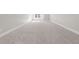 Large, empty bedroom featuring carpet floors, white trim and a sunny window at 125 Sue-Kim Dr, Youngsville, NC 27596