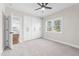 Bright bedroom with carpeted floors, view to the kitchen and a large window at 125 Sue-Kim Dr, Youngsville, NC 27596
