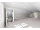 Spacious bonus room with recessed lighting, carpet floors, and stairs in the background at 125 Sue-Kim Dr, Youngsville, NC 27596