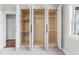 Walk in closet with open shelving and a view to the bedroom and its carpeted floor at 125 Sue-Kim Dr, Youngsville, NC 27596