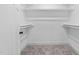 Empty walk-in closet with carpeted floors, white walls and white shelving at 125 Sue-Kim Dr, Youngsville, NC 27596