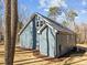 Side view of a well-maintained blue house with new landscaping, a gray roof, and white trim at 125 Sue-Kim Dr, Youngsville, NC 27596