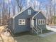 Gray house with brick foundation, multiple windows, and a small front porch and steps at 125 Sue-Kim Dr, Youngsville, NC 27596