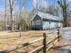 View of the side of the house and a gravel driveway, surrounded by a yard with trees at 125 Sue-Kim Dr, Youngsville, NC 27596