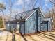 A modern blue house with a gray roof, multiple windows, and newly installed landscaping at 125 Sue-Kim Dr, Youngsville, NC 27596