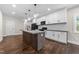 Modern kitchen with stainless steel appliances, dark wood floors and a center island with gray countertops at 125 Sue-Kim Dr, Youngsville, NC 27596