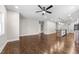 Open-concept living space featuring hardwood floors and a kitchen island with modern pendant lighting at 125 Sue-Kim Dr, Youngsville, NC 27596