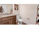 Powder room with granite countertop, dark wood vanity, and wood flooring at 130 Daniel Farm Dr, Benson, NC 27504