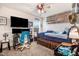 This bedroom features a ceiling fan, a large TV, and displays of sports memorabilia at 130 Daniel Farm Dr, Benson, NC 27504