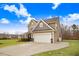 Two-story house with a large garage and landscaped lawn at 130 Daniel Farm Dr, Benson, NC 27504