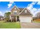 Two-story house with a large garage and landscaped lawn at 130 Daniel Farm Dr, Benson, NC 27504