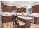 Bright kitchen with stainless steel appliances, granite countertops, white backsplash, and an island with barstool seating at 130 Daniel Farm Dr, Benson, NC 27504
