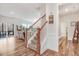 View of the light filled living room with wood floors, fireplace, and access to outdoor deck at 130 Daniel Farm Dr, Benson, NC 27504