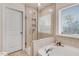 Main bathroom showcasing glass shower, soaking tub, and natural light from the window at 130 Daniel Farm Dr, Benson, NC 27504