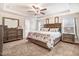 Spacious main bedroom features a tray ceiling, neutral carpet, and adjoining ensuite at 130 Daniel Farm Dr, Benson, NC 27504