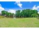 Scenic view of the lush backyard merging seamlessly with a peaceful pond at 130 Daniel Farm Dr, Benson, NC 27504