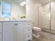 Bathroom featuring tiled shower, toilet, and vanity with marble countertops at 1324 Brooks Ave, Raleigh, NC 27607