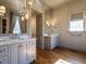 Bright bathroom features double vanity, marble countertops, wooden floors, and decorative lighting at 1324 Brooks Ave, Raleigh, NC 27607