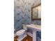 Stylish bathroom with a designer sink, vintage mirror, and unique tiger-themed wallpaper at 1324 Brooks Ave, Raleigh, NC 27607