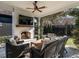 Inviting covered patio with a brick fireplace, comfortable wicker furniture, and a view of the manicured backyard at 1324 Brooks Ave, Raleigh, NC 27607