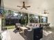 Spacious covered patio with stone flooring, wicker furniture, and a view of the well-maintained backyard at 1324 Brooks Ave, Raleigh, NC 27607