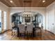 Elegant dining room open to the Gathering room features hardwood floors and statement lighting at 1324 Brooks Ave, Raleigh, NC 27607