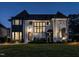 Stunning home exterior showcasing Tudor design, dark window trim, beautiful lawn, and elegant front entrance at 1324 Brooks Ave, Raleigh, NC 27607