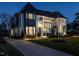 An elegant home with a well-lit walkway leading to the entrance, highlighting the beautiful architecture at dusk at 1324 Brooks Ave, Raleigh, NC 27607