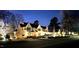 Inviting exterior view of a charming home with a well-lit entrance and professionally landscaped yard at 1324 Brooks Ave, Raleigh, NC 27607