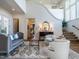 Elegant foyer with staircase, hardwood floors, and stylish seating offers a sophisticated welcome to the home at 1324 Brooks Ave, Raleigh, NC 27607