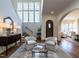 Inviting foyer with hardwood floors, staircase, high ceiling, arched doorway, and a sitting area at 1324 Brooks Ave, Raleigh, NC 27607