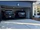 Spacious garage featuring two vehicles and access to an outdoor living space at 1324 Brooks Ave, Raleigh, NC 27607