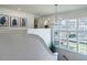 Bright hallway featuring staircase, large windows, and modern decor at 1324 Brooks Ave, Raleigh, NC 27607