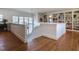 Bright hallway featuring hardwood floors, staircase, built-in bookcase, and large windows at 1324 Brooks Ave, Raleigh, NC 27607