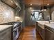 Gourmet kitchen showcasing a range, custom vent hood, and countertops with bar seating at 1324 Brooks Ave, Raleigh, NC 27607