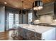 Modern kitchen featuring a spacious island, seating, and modern light fixture at 1324 Brooks Ave, Raleigh, NC 27607