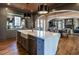 Open-concept kitchen features a large island, wood-paneled ceiling, and seamless flow to the dining room at 1324 Brooks Ave, Raleigh, NC 27607
