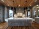 Kitchen boasts a large island with seating, custom cabinetry, and wood-paneled ceiling at 1324 Brooks Ave, Raleigh, NC 27607