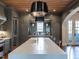 Bright kitchen island with seating and stainless steel appliances is open to dining room at 1324 Brooks Ave, Raleigh, NC 27607
