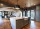 Gourmet kitchen showcasing a large island with bar seating open to a dining room and living room at 1324 Brooks Ave, Raleigh, NC 27607