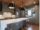 Modern kitchen featuring a spacious island, stainless steel appliances, and custom cabinetry at 1324 Brooks Ave, Raleigh, NC 27607