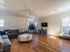 Spacious living room with hardwood floors, a comfortable gray sofa, and a fun basketball hoop for recreation at 1324 Brooks Ave, Raleigh, NC 27607
