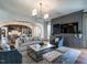 Spacious living area with fireplace, media center, plush seating, and arched entryway to the dining room at 1324 Brooks Ave, Raleigh, NC 27607