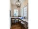 Cozy office space offering natural light from two windows with an ornate lighting fixture at 1324 Brooks Ave, Raleigh, NC 27607