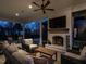 Inviting outdoor living space with fireplace, ceiling fan, and comfortable seating at 1324 Brooks Ave, Raleigh, NC 27607