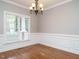 Formal dining room with hardwood floors, wainscoting and chandelier at 212 Rushing Wind Way, Apex, NC 27502