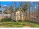 Tan shed with double doors and window in backyard at 2242 Colorado Dr, Graham, NC 27253