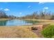 Serene community pond with fountain and bench at 2242 Colorado Dr, Graham, NC 27253