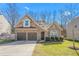 Two-story house with stone and siding accents, two-car garage, and landscaped lawn at 2242 Colorado Dr, Graham, NC 27253